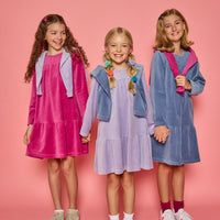 Models can be seen wearing long sleeve dusty blue/magenta/ and lilac velour dresses. Dresses features button closure at back for a relaxed but secure fit.