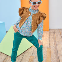 Tween model can be seen wearing a brown suede top, featuring button closures, so it can be worn as a cape/layering piece or as a shirt on its own. Paired back with our brown and green floral and velvet pants to complete the look.