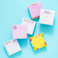 Colorful notepads with various designs and text on a blue background