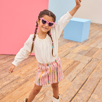 Model can be seen wearing a white pointelle knit top paired back with a skort in multi-color wool. Skort features an elastic waistband and built in shorts for a secure but comfy fit.