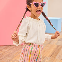 Model can be seen wearing a white pointelle knit top paired back with a skort in multi-color wool. Skort features an elastic waistband and built in shorts for a secure but comfy fit.