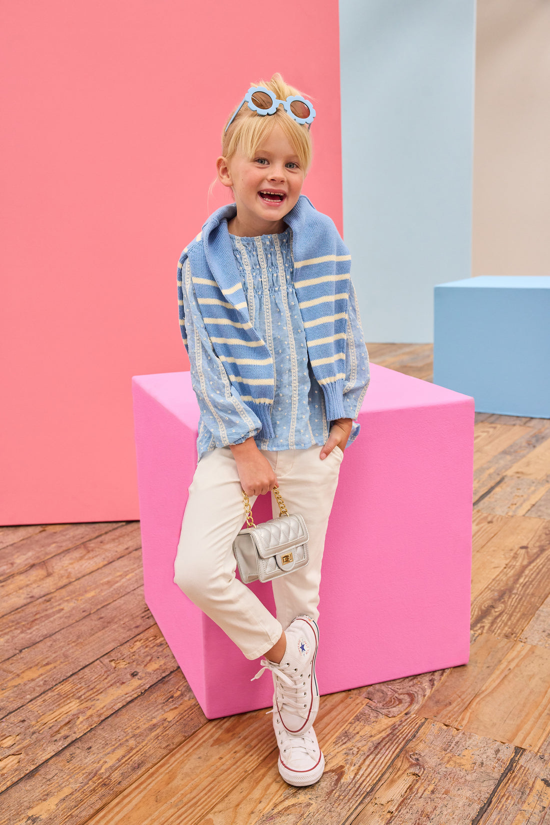 Model can be seen wearing a light blue shirt that features white dobby detailing and white lace stripes which pairs back perfectly with ivory jeans to complete the look.