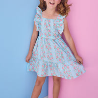 Tween model can be seen wearing a woven light blue/pink floral print that features an elastic waistband and angel flutter sleeves for a secure but comfy fit.