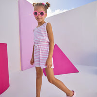 Girls/Tween model can be seen wearing knit romper in light purple/white stripe. Romper features a keyhole button closure at back , an elastic waistband, and pockets.