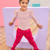 Model can be seen wearing velvet "cranberry" color pants paired back with a stripe knit top to complete the look. Pants feature a snap button closure and zipper for easy pull on access.