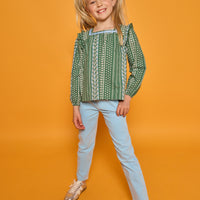 Model can be seen wearing woven long sleeved top with square neckline in a blue/white/green floral print. Paired back perfectly with the light blue corduroy pants to complete the look.