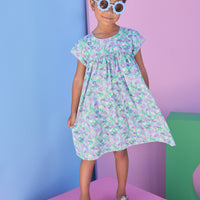 Model can be seen wearing aqua/purple/green floral print that features button closure along back neckline and a beautiful hot pink trim along bust and sleeves to elevate the look.