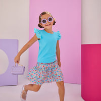 Girls/Tween model can be seen wearing a knit eyelet angel sleeve tank in aqua that pairs back perfectly with this skort in a lilac, aqua, red floral pattern to complete the look.