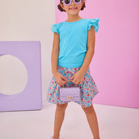 Girls/Tween model can be seen wearing a knit eyelet angel sleeve tank in aqua that pairs back perfectly with this skort in a lilac, aqua, red floral pattern to complete the look.