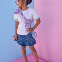 Model can be seen wearing a denim mini skirt that features ruffle detail and button closure for a secure fit. Pair skirt back with a ric rac tee to complete the look.