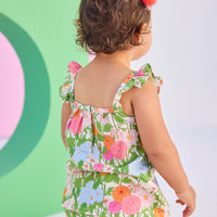 Baby model can be seen wearing a two piece woven bloomer set in a beautiful green/pink/orange/light blue floral print. Top features button closure at end of straps along back, and bottoms are easy pull on style for a secure but comfy fit.