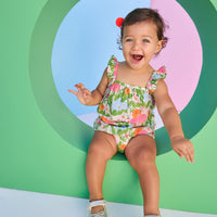 Baby model can be seen wearing a two piece woven bloomer set in a beautiful green/pink/orange/light blue floral print. Top features button closure at end of straps along back, and bottoms are easy pull on style for a secure but comfy fit.