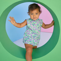 Baby model can be seen wearing a woven bloomer set in an aqua/green/purple floral print. Top of set features button closure at back and bottom features elastic waistband for easy put on/pull off access.