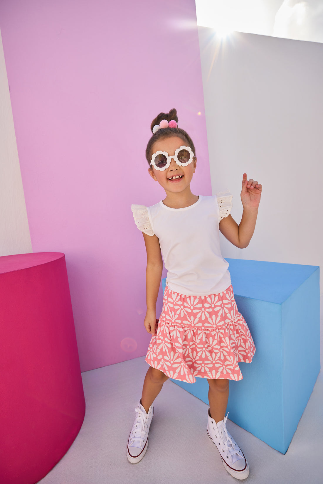 Girls/Tween model can be seen wearing a knit eyelet angel sleeve tank that pairs back perfectly with this skort in a salmon and white floral pattern.