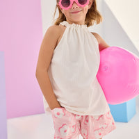 Girls/Tween woven shorts in a light pink and white floral print. Shorts have an elastic waistband and pockets in the front for a comfy and secure fit. Model can be seen pairing these shorts with our sleeveless tank top in a gorgeous white pointelle fabric.