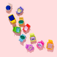 Colorful hair clips on a pink background