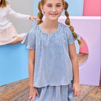Tween model can be seen wearing a matching blue set that has shiny silver stars printed on a blue stretchy fabric.