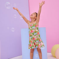 Model can be seen wearing woven strappy dress in a green/orange/pink/light blue floral print. Dress features button closures along back and made of a super soft woven material for a comfy but secure fit.