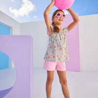 Model can be seen wearing knit bubblegum pink shorts that feature an elastic waistband and functional pockets in the front of shorts. Shorts pair back perfectly with floral woven top to complete the look.