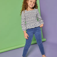 Model can be seen wearing a long sleeve woven top that features elastic ruching throughout the body of the shirt. Made of a blue and white floral print, the top pairs back perfectly with our dusty blue corduroy pants that have two pockets and button closure at waistband.