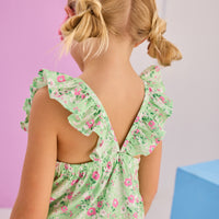 Girls/Tween woven dress in a light green/pink floral print. Dress features adjustable ruffle/angel sleeve straps with button closure at back for a secure but relaxed fit.