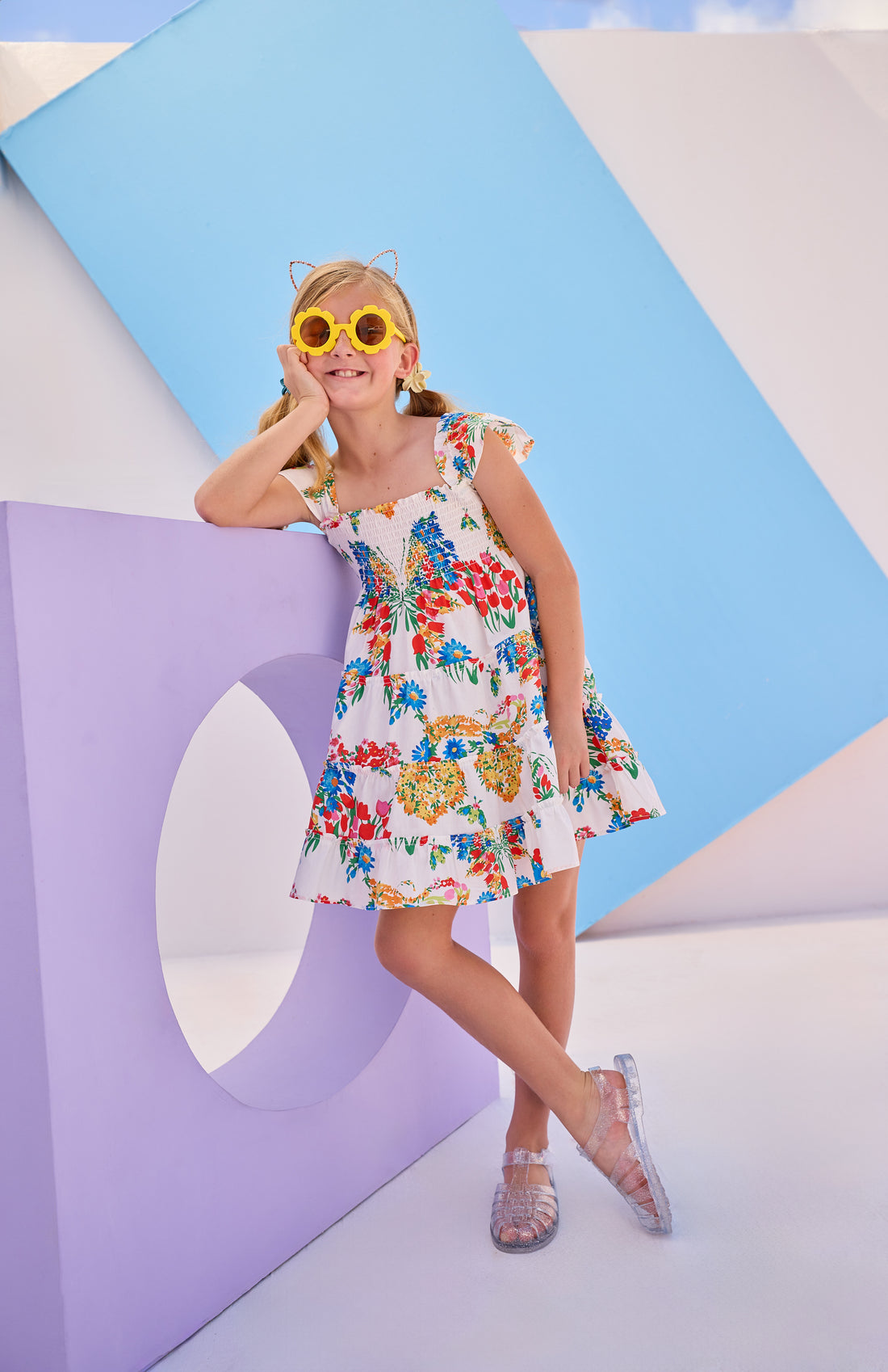 Model can be seen wearing woven dress with multi colored floral arrangement. Dress features angel sleeves and ruching at bust for a comfy and airy fit perfect for spring and summer.
