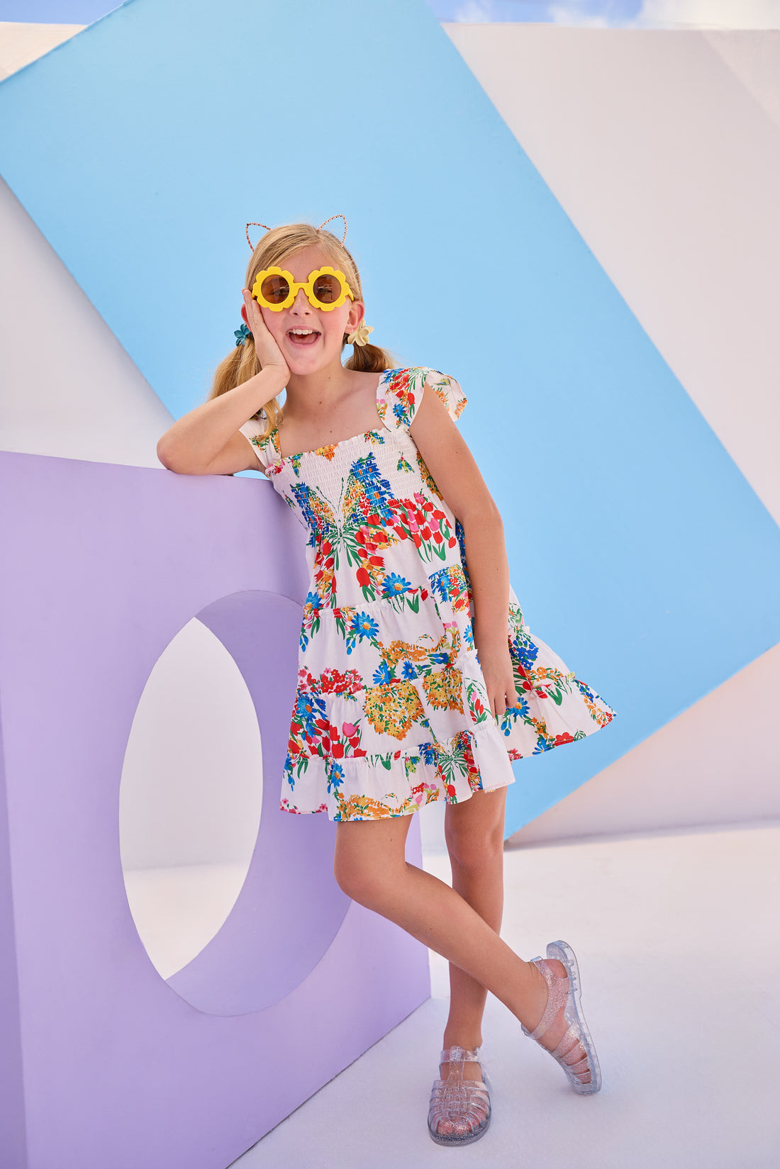 Model can be seen wearing woven dress with multi colored floral arrangement. Dress features angel sleeves and ruching at bust for a comfy and airy fit perfect for spring and summer.