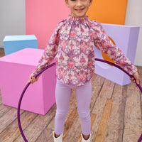 Tween model can be seen in a pink floral top paired back with our soft and stretchy lilac leggings.