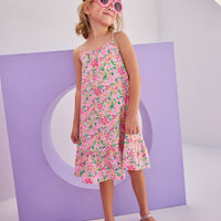 Model can be seen in woven dress with thin straps in a hot pink/yellow/white floral pattern. Dress is made up of a lightweight woven material for a perfect spring/summer dress.