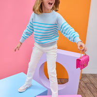 Tween model can be seen wearing a light aqua and turquoise stripe sweater paired back with ivory jeans to complete the look.