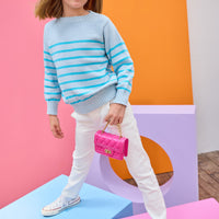 Tween model can be seen wearing a light aqua and turquoise stripe sweater paired back with ivory jeans to complete the look.