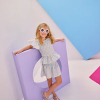 Model can be seen wearing gorgeous woven top that has a ruching feature across middle of top. Top is made of yellow and white flowers printed on a light blue background and also features angel sleeves to complete the look. Paired back perfectly with our shirred circle skirt in the same print for a complete set.