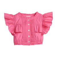 Girls/Tween lightweight woven top in hot pink featuring button closures along the front, angel sleeves, and gathering detail for an elevated spring look.