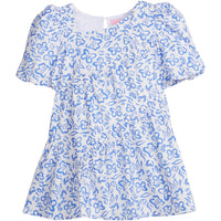 Girls/Tween woven dress in a royal blue and white floral pattern. Dress features a fun asymmetrical hem which adds a fun feature to the dress. Dress also has slight puff sleeves and also has a keyhole button closure on back of neckline.