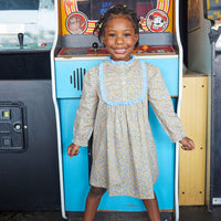 Little girl can be seen wearing our Chelsea Dress in our Devon Floral Amber-BISBY girl