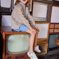 Model can be seen wearing our Chelsea Top in our Devon Floral Amber with our Mini Skirt in French Blue Sherpa on the bottom to complete the look-BISBY Girl
