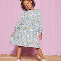 Model can be seen rocking our Elena Dress in our Jodphur Floral White pattern--BISBY girl