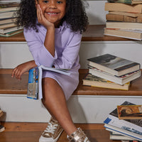 Model can be seen wearing our Tory Dress in Lilac with ruffles around the top--BISBY girl