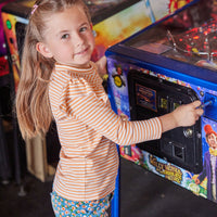 Little girl can be seen rocking our Blue Floral Corduroy Twiggy Cords paired with our Orange Sparkle Stripe shirt--BISBY girl