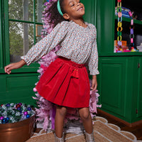 Our model can be seen rocking our Tory Top in our Christmas Vine print paired great with our Circle Skirt in Red Velvet--BISBY girl