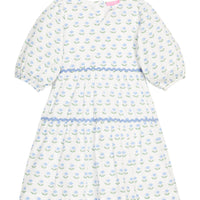 BISBY girl woven white dress in blue/green floral print. Dress features three button closure along back, elastic cuffs at sleeve, and blue ric rac detail across tiers of dress for an elevated look.