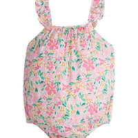Baby girl woven bubble featured in a bright pink/yellow/green floral print. Bubble features ruffle straps and button closures along back and stride for easy put on access.