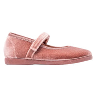 Pink velvet flat shoe mary jane with a strap on a white background