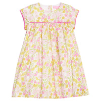 BISBY girl woven dress in a yellow/pink floral print. Dress features three button closure at back and hot pink trim across bust and end of sleeves for a completed look.