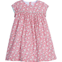 Girls dress featuring our Bedford Gardens Pink Floral. Dress has an aqua trim that goes along the ends of the short sleeves and across the bust of the dress. Dress also has buttons along back making it easy to get in and out of-BISBY