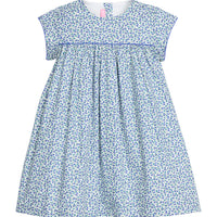 Girls woven short sleeve dress in a blue floral pattern that features button closure at back of neckline. Dress also features a blue trim across bust and end of sleeves for an elevated look.