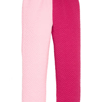 Girls pink and magenta quilted pants with one leg being a bubblegum pink and the other in a cranberry pink. Joggers also feature an elastic waistband and functioning ties.