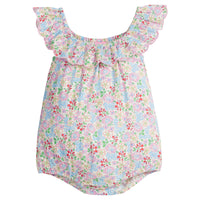 Baby girl woven bubble in a pale yellow/pink/red/blue/green floral print. Bubble also features a ruffle neckline that continues to the back and button closures at the stride for easy put on access.