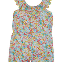 Girl/tween romper with pockets, has scalloped neckline with yellow trim and an elastic waistband, and beautiful red, yellow, and blue floral print