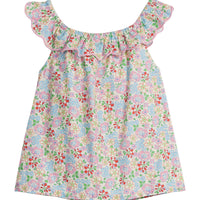 Girls/Tween woven top in a pale yellow/pink/green/red floral print. Top features a ruffle/scallop neckline that continues to the back and has a nice light pink trim.